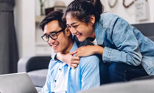 Two people watching laptop